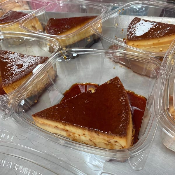 Several slices of flan with caramel topping in clear plastic takeout containers.