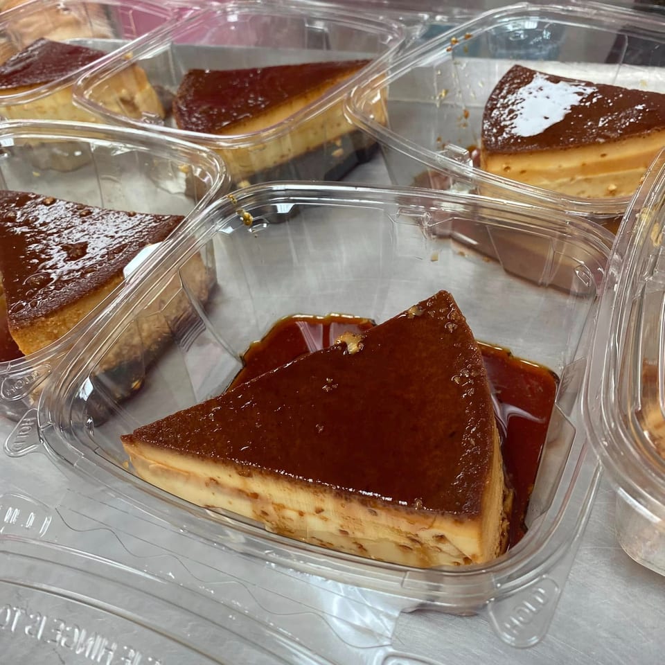 Several slices of flan with caramel topping in clear plastic takeout containers.